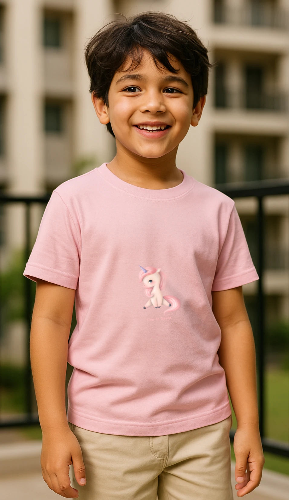 Child wearing a pink t-shirt with a pony design outdoors.