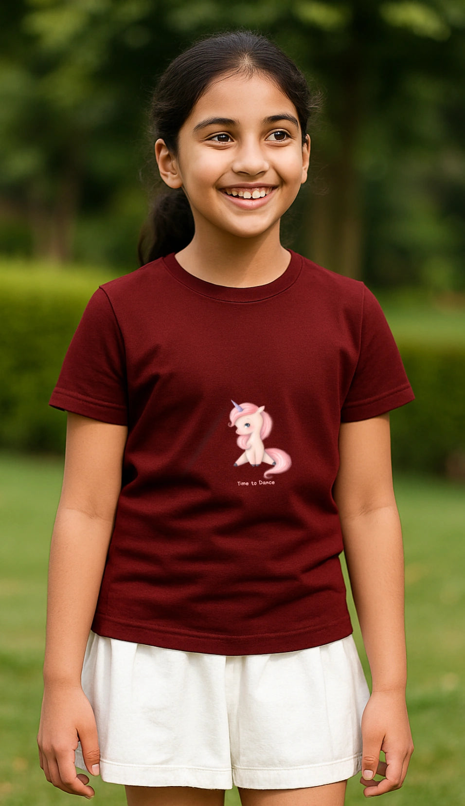 Young girl wearing a maroon t-shirt with a pony design outdoors