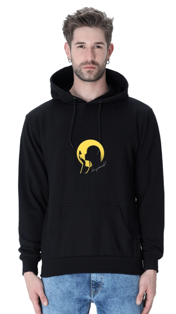 Person wearing a black hoodie with a yellow graphic design on a white background