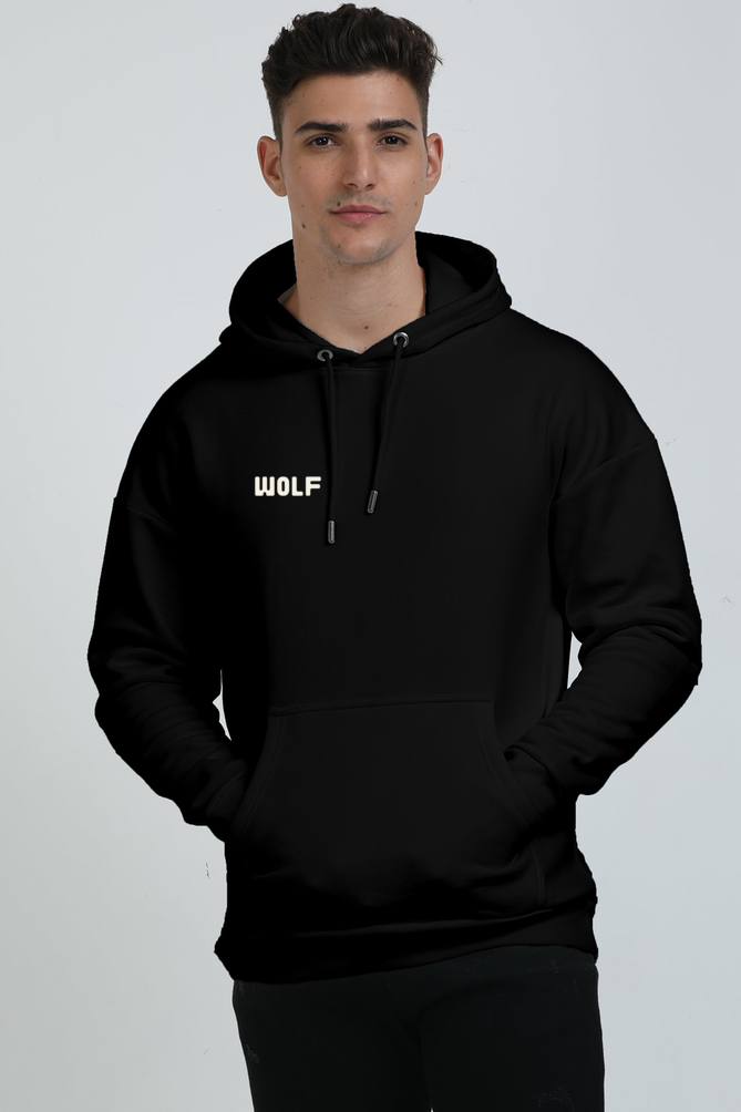 A man wearing a Black hoodie with a  text 'WOLF' on the pocket area of hoodie.