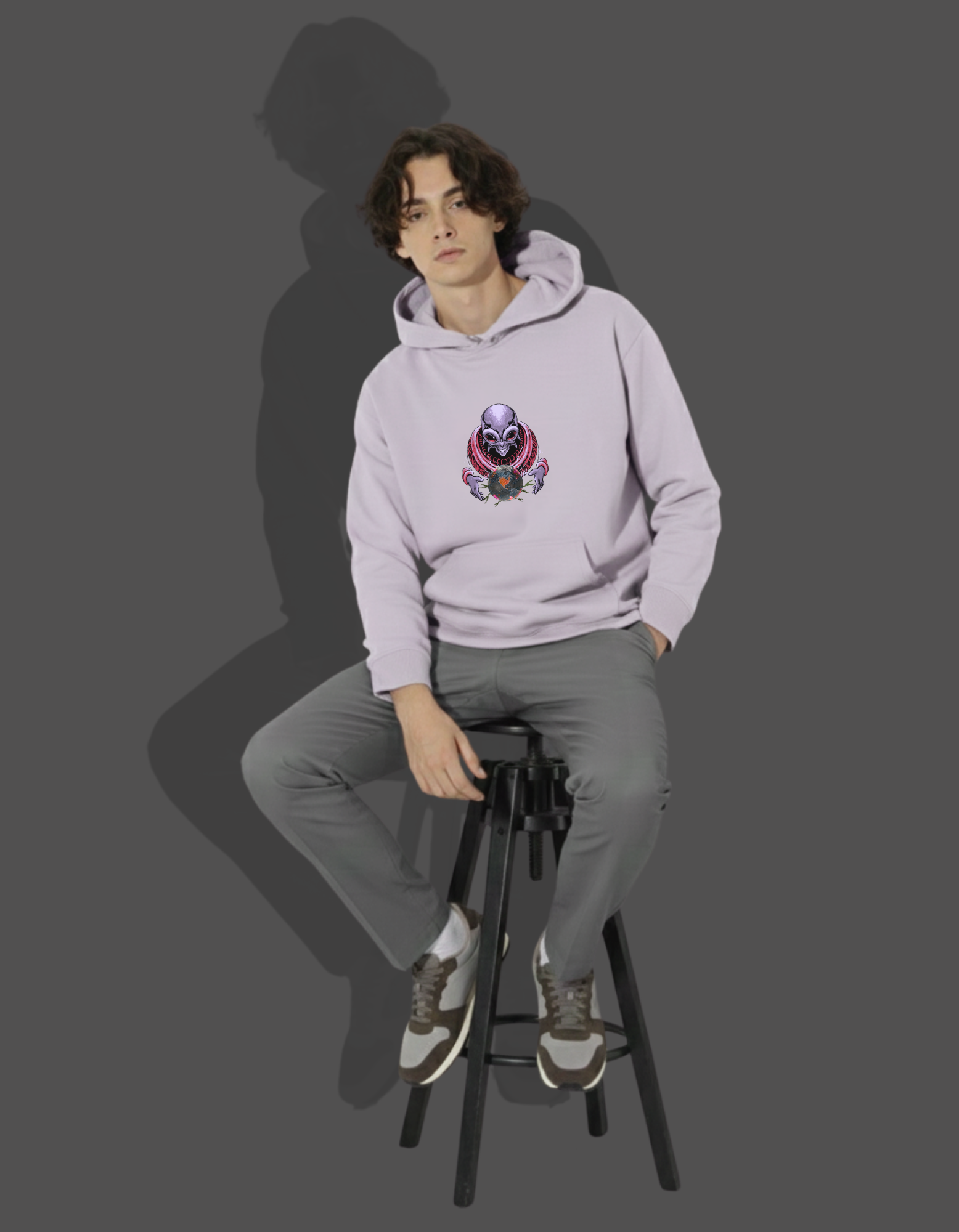Man sitting in Lavender Heavyweight Hoodie. Urbanwear graphic. 320 GSM fleece for casual comfort.