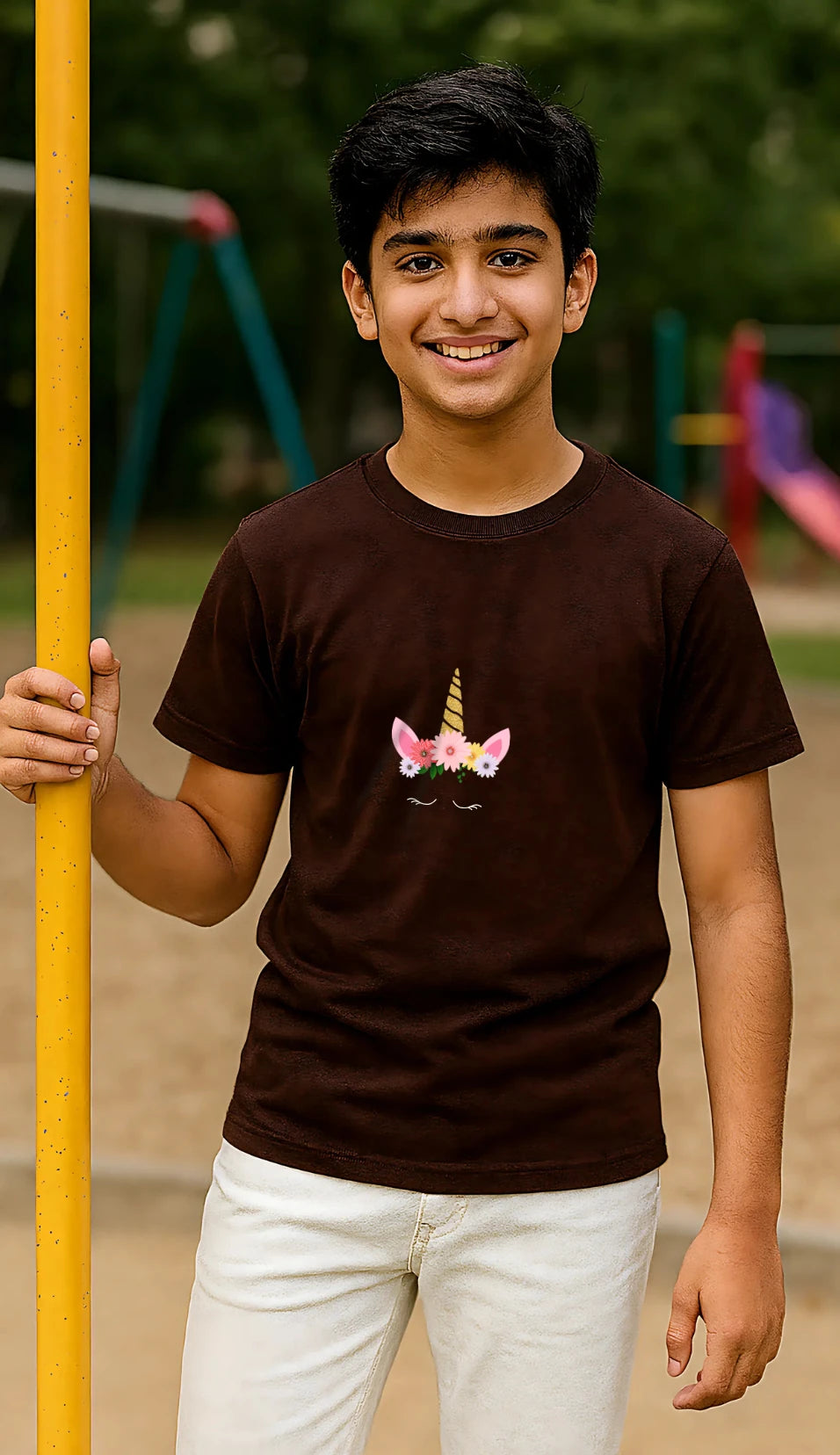 Young boy wearing a brown t-shirt with a pony crown design outdoors