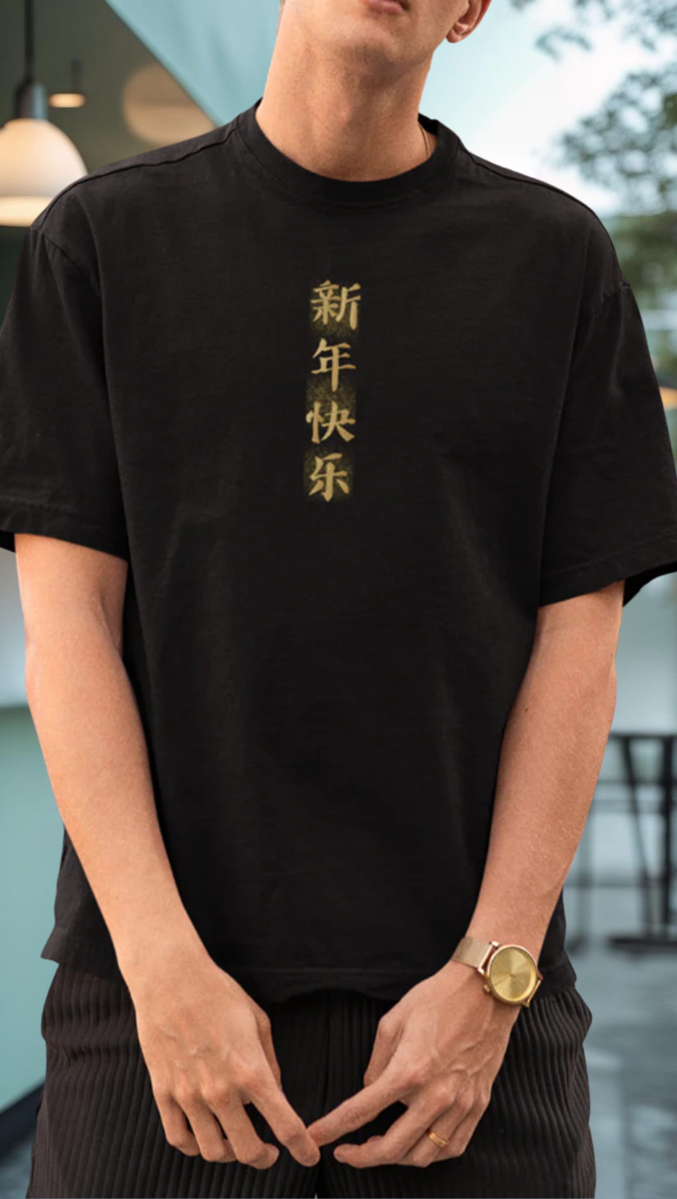 Person wearing a black t-shirt with dragon written in Chienese in gold text.