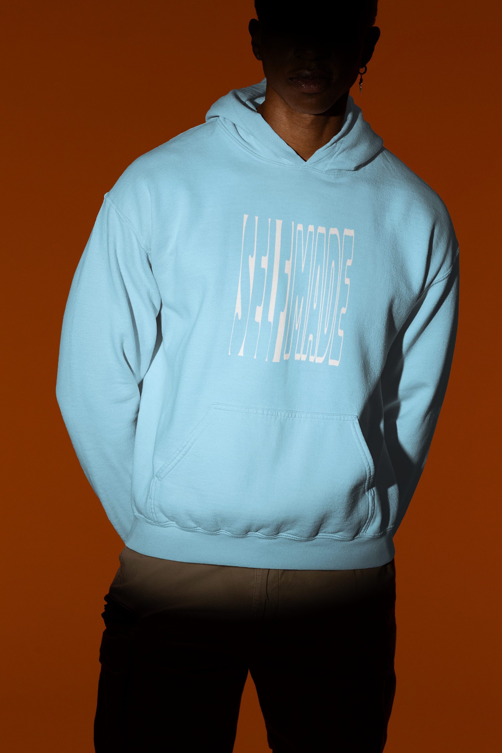 Male model in a Baby Blue 300 GSM cotton hoodie with 'Self Made' graphic for college and everyday wear.