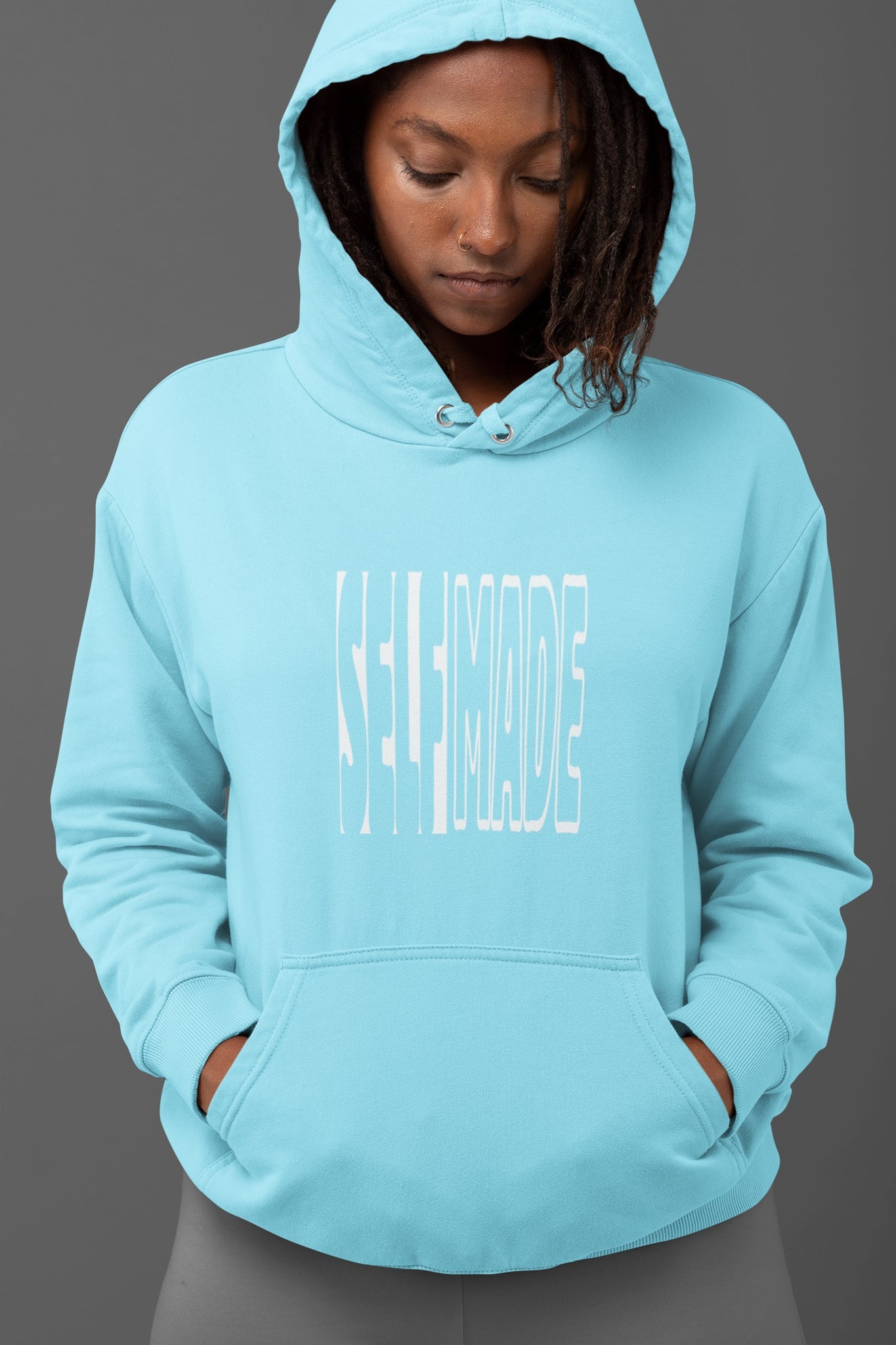 Female model in Baby Blue 300 GSM hoodie with a 'Self Made' statement graphic for street style and layering.