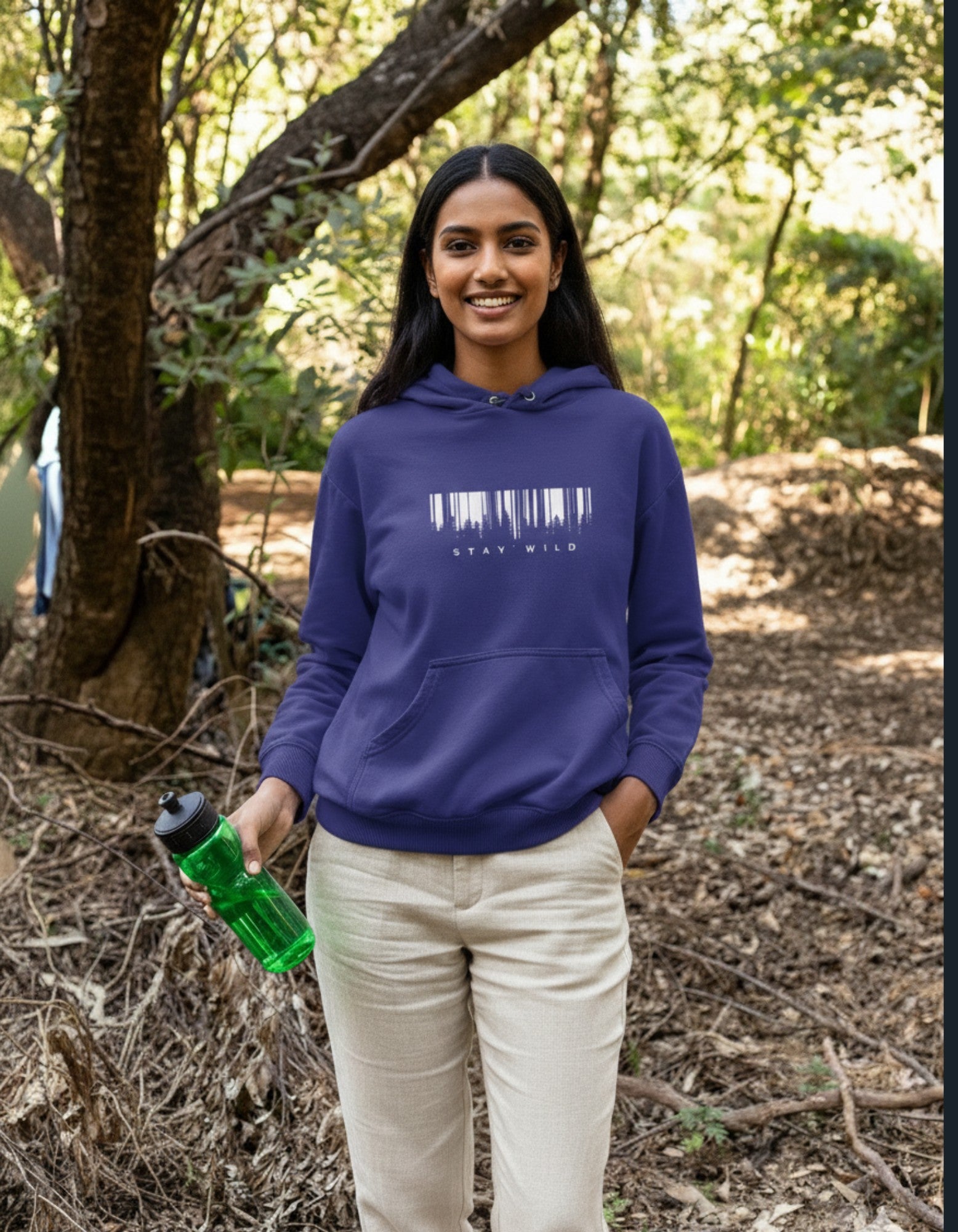Person wearing a royal blue hoodie with a stay wild design, outdoors
