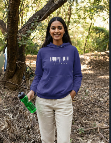 Person wearing a royal blue hoodie with a stay wild design, outdoors