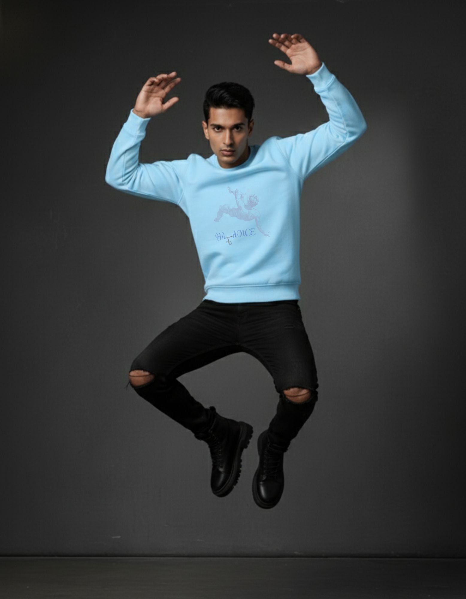 320 GSM  Baby Blue Cotton Sweatshirt on man with print of losing Balance falling in grey with text "balance" under it in blue .