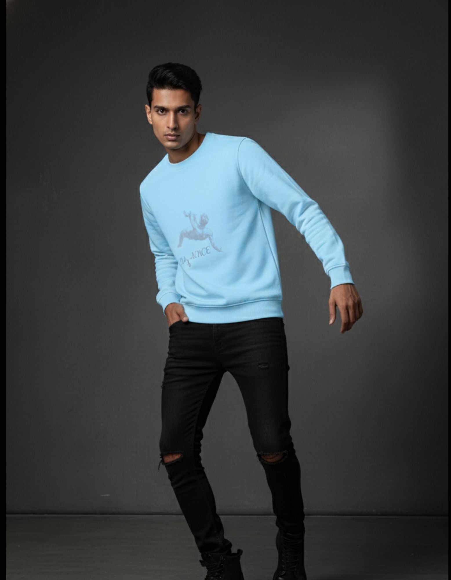 Baby Blue 320 GSM Sweatshirt on man posing casually, hand in pocket. Unisex crew neck with Balance Graphic chest print.